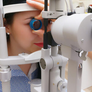 Doctor examining the optic nerve using a biomicroscope and lens